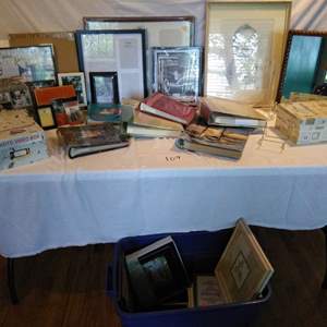 Lot # 109 - Tons of new photo albums, frames, more. 2 tubs of frames, photo boxes. Nice wood Mirror 15x13