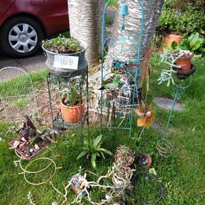 Lot # 168 - White wire fencing, 2 trellis, wind chimes, plants, stands & more