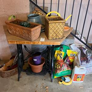 Lot # 138 -  Potting Bench, Assorted Planters, Pots, and Potting Mix.