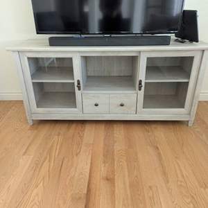 Lot #1 -  Modern TV Stand - Whitewashed Wood Finish with Glass Doors.