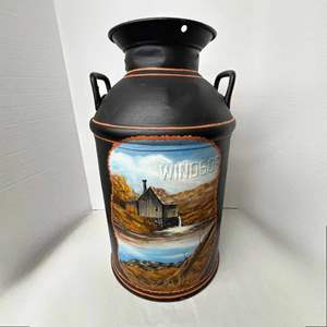 Lot #566 -  Vintage Authentic Hand-Painted Milk Can featuring a serene landscape scene with a wooden cabin and flowing water.