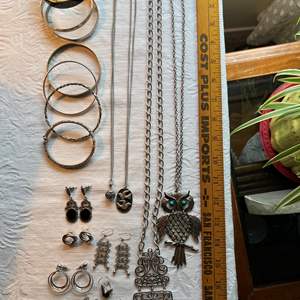 Lot #79 - 7 bangles, 6 pairs of earrings, 4 necklaces, 1 prayer box charm, all silver-tone