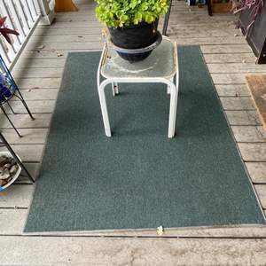 Lot #337 - Outdoor rug, small table, blue bowl, plant