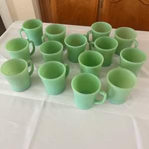 Lot #121 - 14 Fire King Vaseline glass coffee mugs