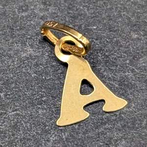 Lot #345 - 18k Gold A Pendant (.06g)