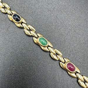 Lot #4 - 14 karat gold bracelet with ruby, sapphire, and emeralds (appraisal included $3745.)