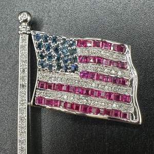 Lot #8 - Articulating flag pole made of 14k white gold set with diamonds, rubies, and sapphires (appraisal included $4,805)