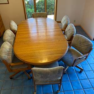 Lot #11 - Dining room table with 8 chairs (with casters), 2 leaves and felt pads