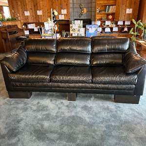 Lot #103 - Leather couch (currently on risers)