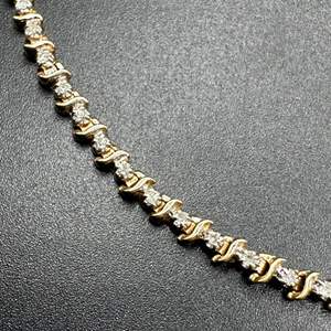 Lot #123 - 14 karat, gold and diamond tennis bracelet (8.8g)