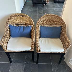 Lot #114 - Two wicker & Wood Chairs with down feather back pillows, each with blue and cream slip cases