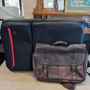 Lot #208 - Suitcase with articulating wheels and briefcase