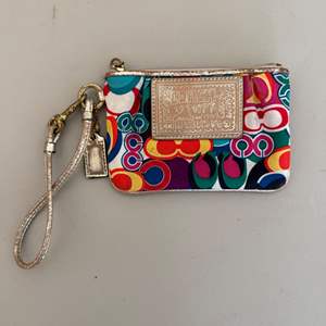 Lot #245  - Authentic Coach wristlet 