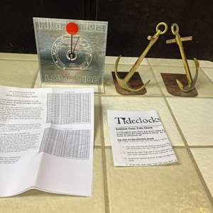 Lot #302 - Tide clock and nautical themed book ends