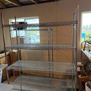 Lot #115  - 4 shelf adjustable metal storage rack on wheels