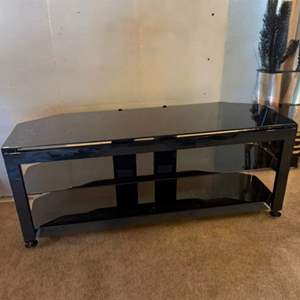 Lot #117  - Black glass top entertainment center. Sleek 