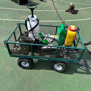 Lot #127  - Gardening cart with air tires filled with assorted gardening supplies 