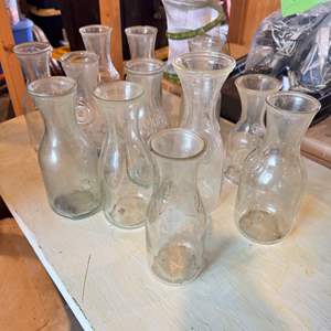 Lot #176  - Box full of vintage glass wine carafes and milk bottles