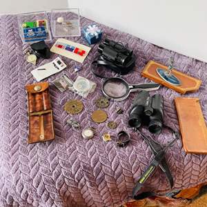 Lot #279- Misc inside dresser finds.. binoculars, magnified glass, coins, watch, compass & more